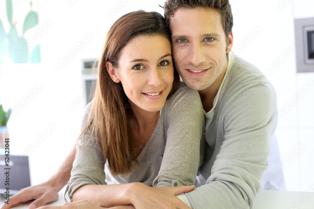 Portrait of cheerful couple standing at home Portrait of cheerful couple standing at home