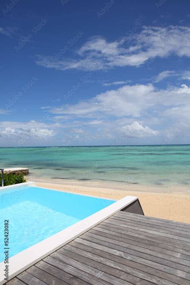 Beautiful view of infinity pool with wooden deck Beautiful view of infinity pool with wooden deck