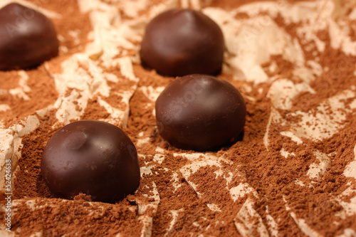 Chocolate candies with cocoa powder, close up