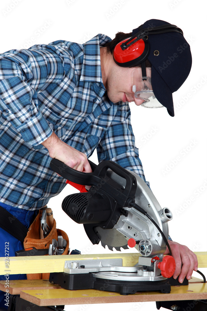 Fototapeta premium Man using a miter saw