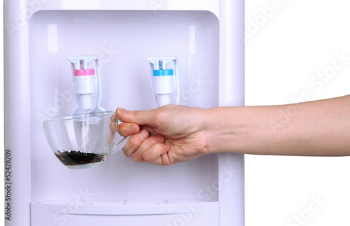 Woman filling cup at water cooler