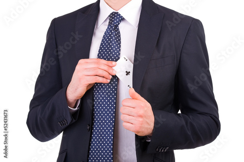 Businessman putting ace card in his pocket.