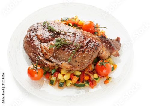 Ribeye steak with stir fried vegetables isolated on white