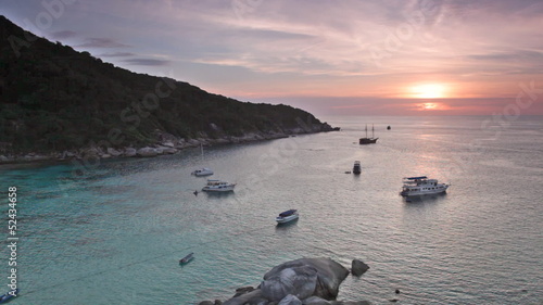 Yachts and boats in calm Andaman Sea during sunset, Thailand photo