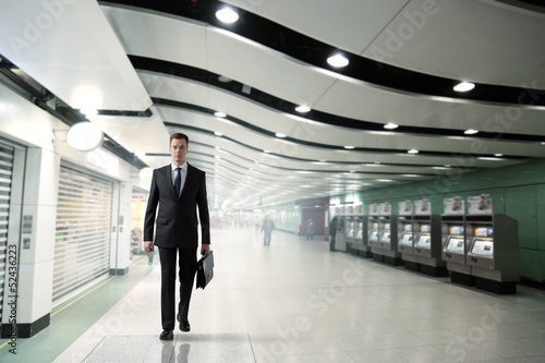 business man walking in subway