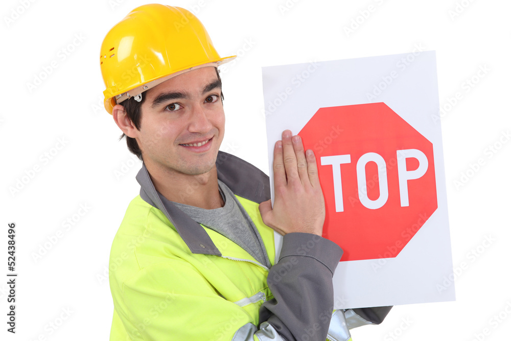 young bricklayer wearing safety jacket and stop sign young bricklayer wearing safety jacket and stop sign