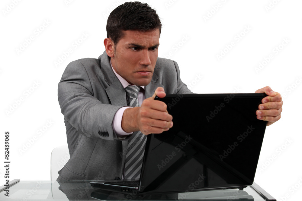 Businessman alarmed at his laptop Businessman alarmed at his laptop