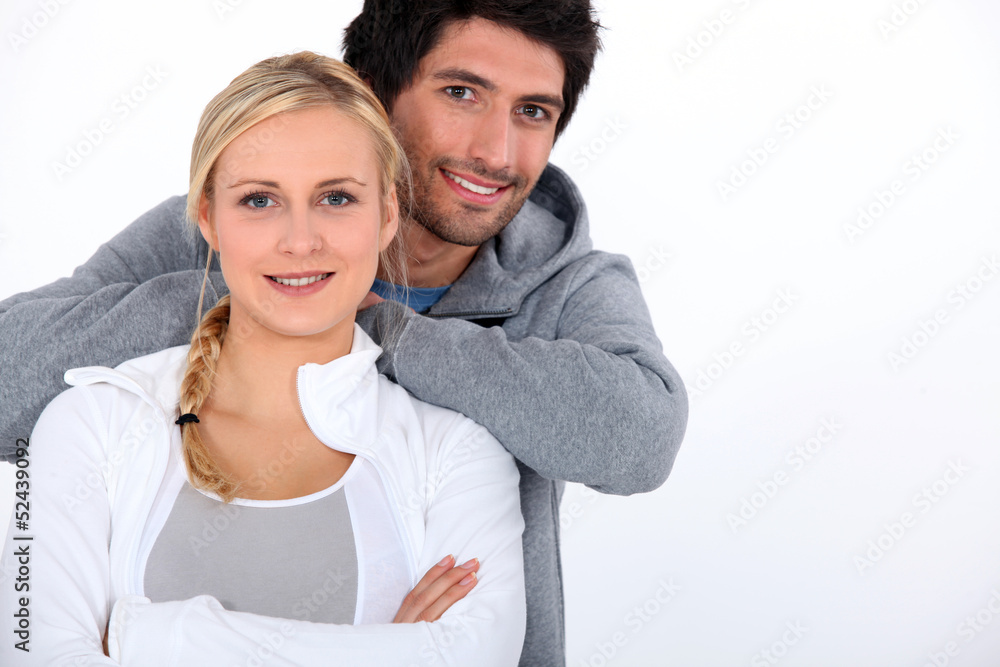 Couple smiling with arms crossed Couple smiling with arms crossed