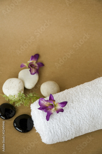 orchid on towel with brown background