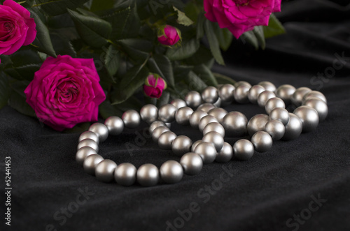 pearl bracelets and bouquet of roses