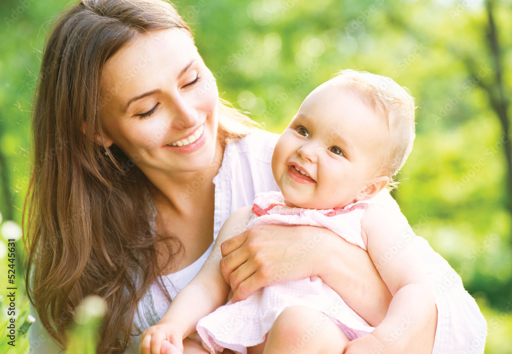 Beautiful Mother And Baby outdoors. Nature Beautiful Mother And Baby outdoors. Nature