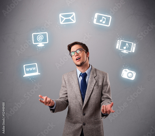 funny boy juggling with electronic devices icons © ra2 studio
