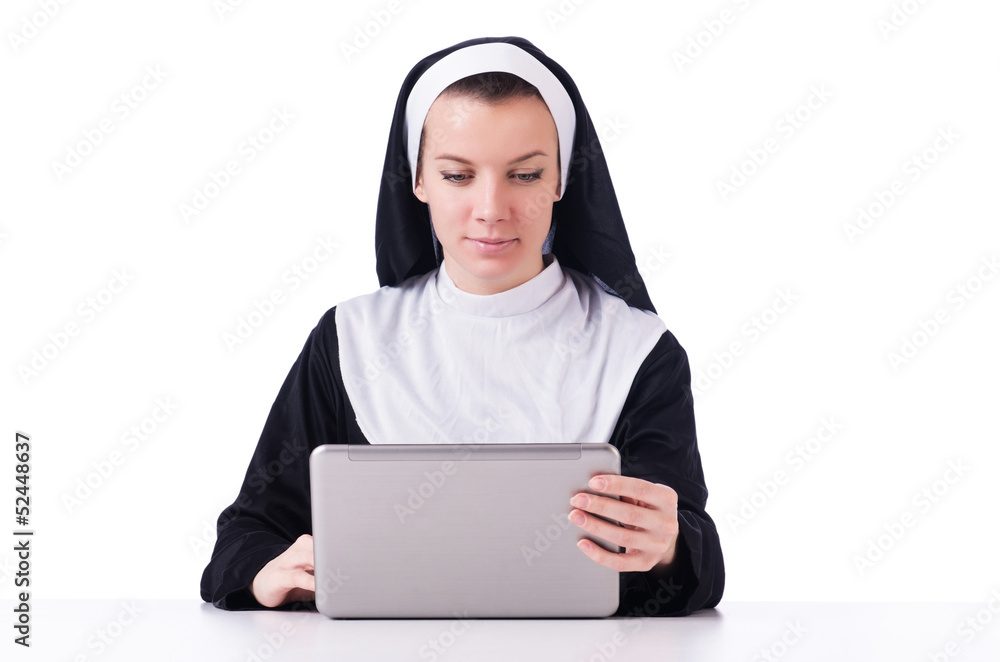 Nun working on laptop - religious concept Nun working on laptop - religious concept