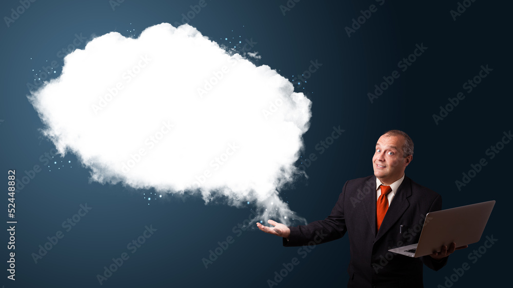 Businessman holding a laptop and presenting abstract cloud copy Businessman holding a laptop and presenting abstract cloud copy