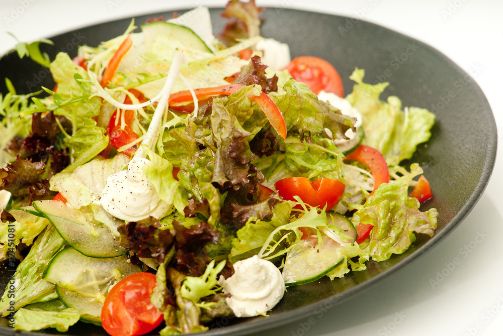 Healthy green salad on the black plate Healthy green salad on the black plate