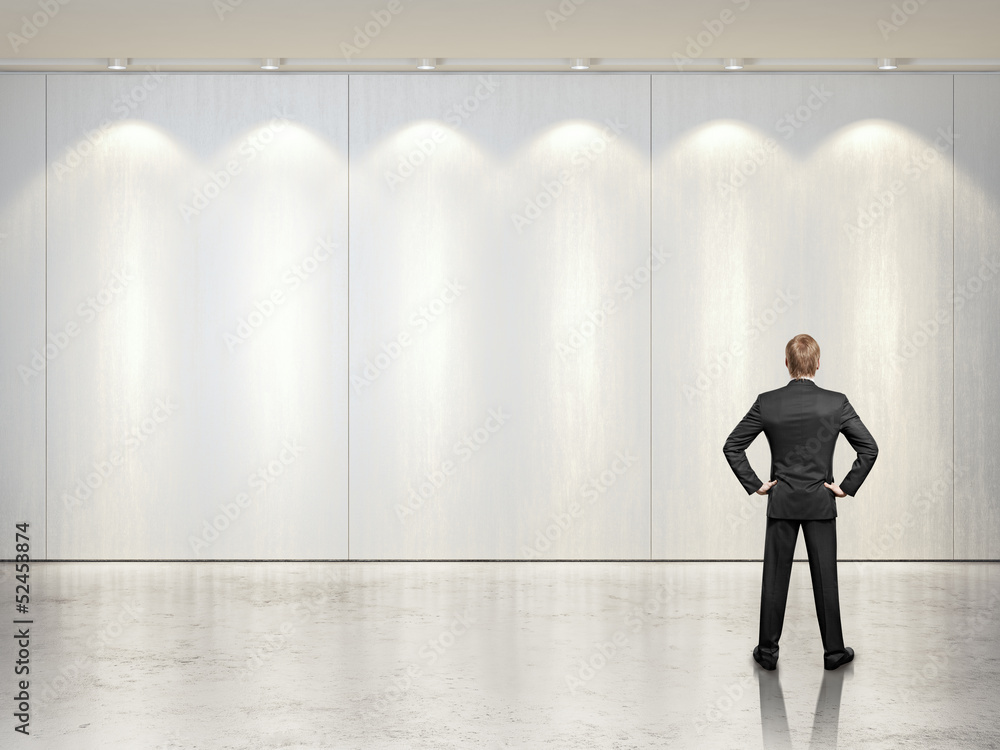 Fototapeta premium businessman looking on the wall