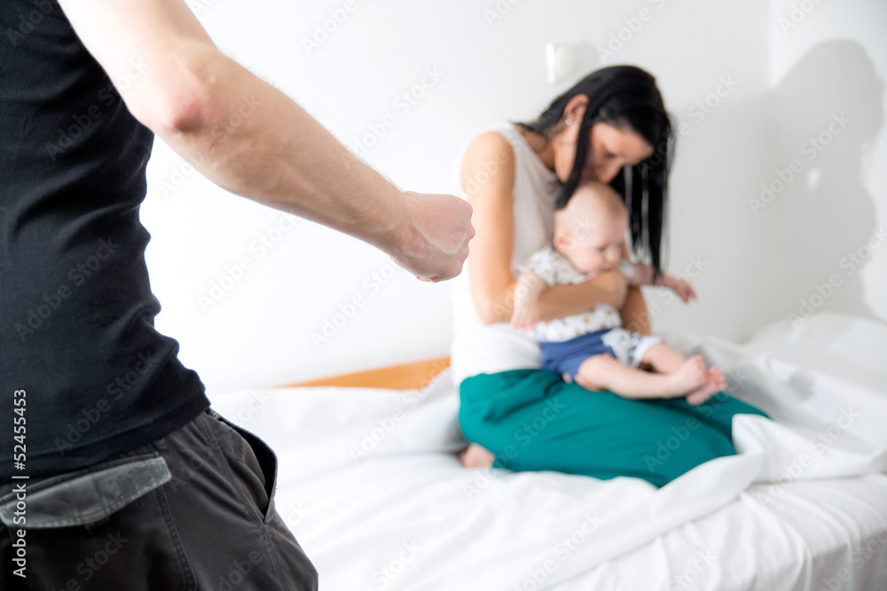 Men beating his wife and child at home Men beating his wife and child at home