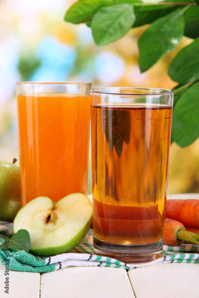 Glasses of juice, apples and carrots Glasses of juice, apples and carrots