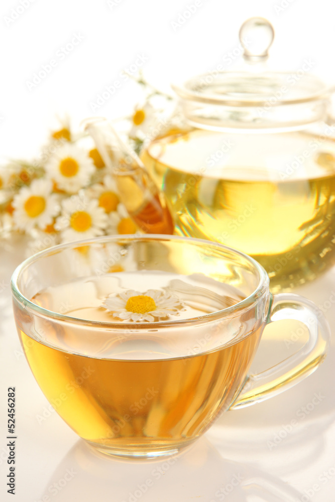 Cup of herbal tea with camomiles close up Cup of herbal tea with camomiles close up