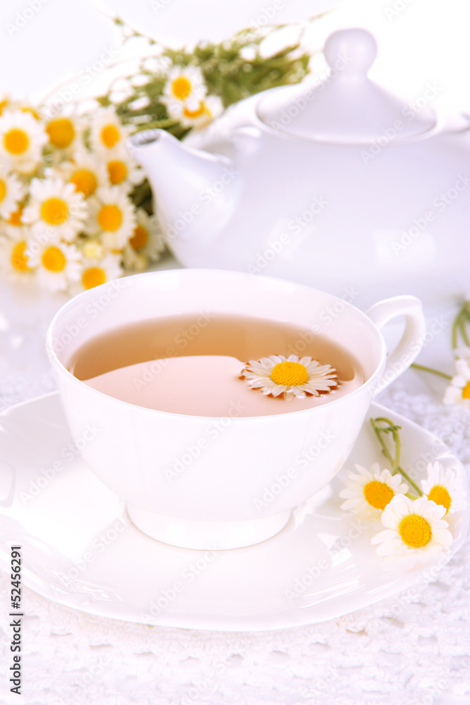 Cup of herbal tea with camomiles close up Cup of herbal tea with camomiles close up