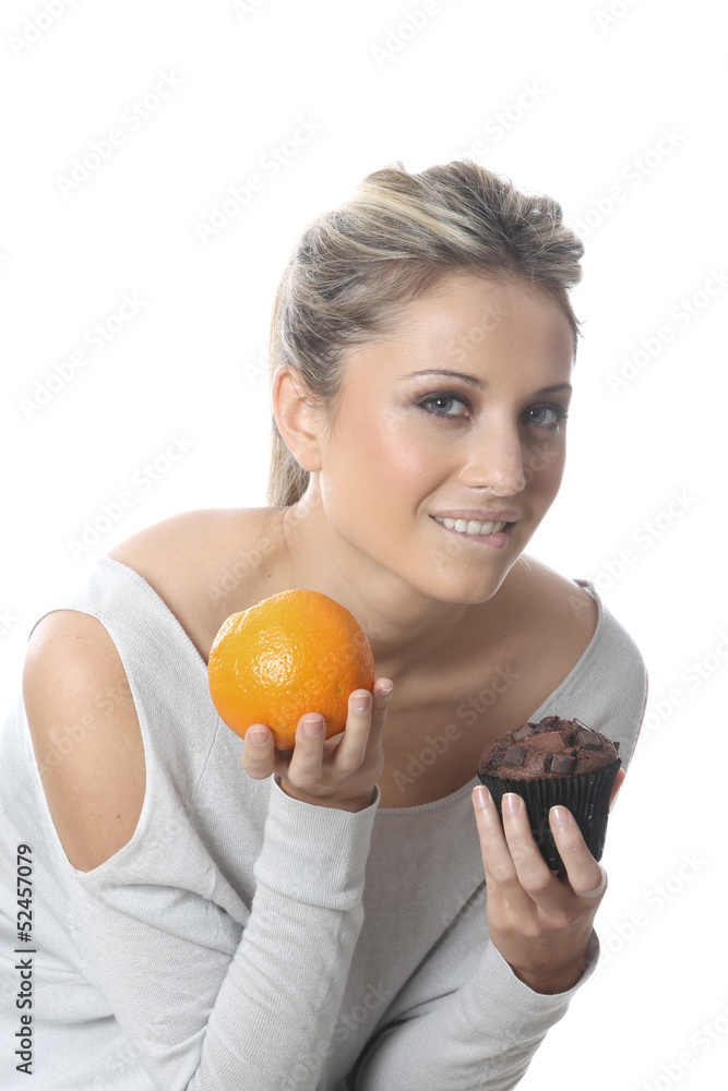 Model Released. Young Woman Holding an Orange and Cake Model Released. Young Woman Holding an Orange and Cake