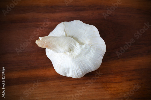 Whole garlic bulb or head of garlic cloves on a wooden desk