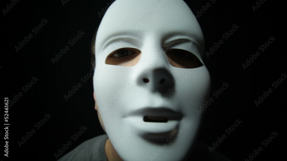 Scary masked man over dark background Scary masked man over dark background