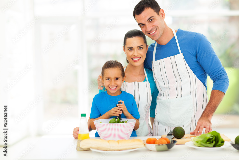 adorable young family cooking at home
