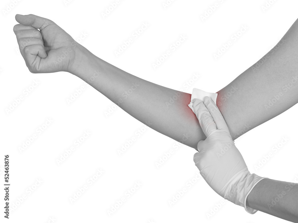 Hand pressing gauze on arm after administering an injection.