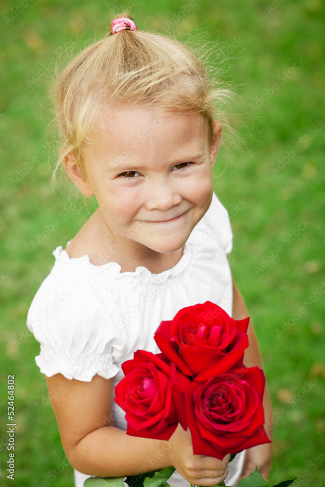 happy child with a bouquet of red roses happy child with a bouquet of red roses