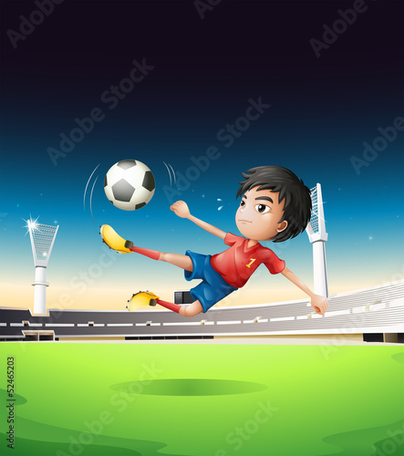 A boy in a red uniform at the soccer field