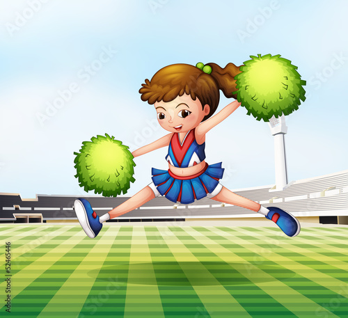 A cheerdancer with green pompoms at the soccer field