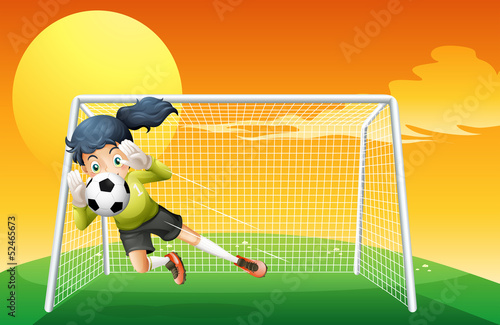 A female soccer player catching the ball