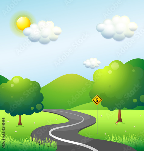 A curve road with a curve sign along the mountain