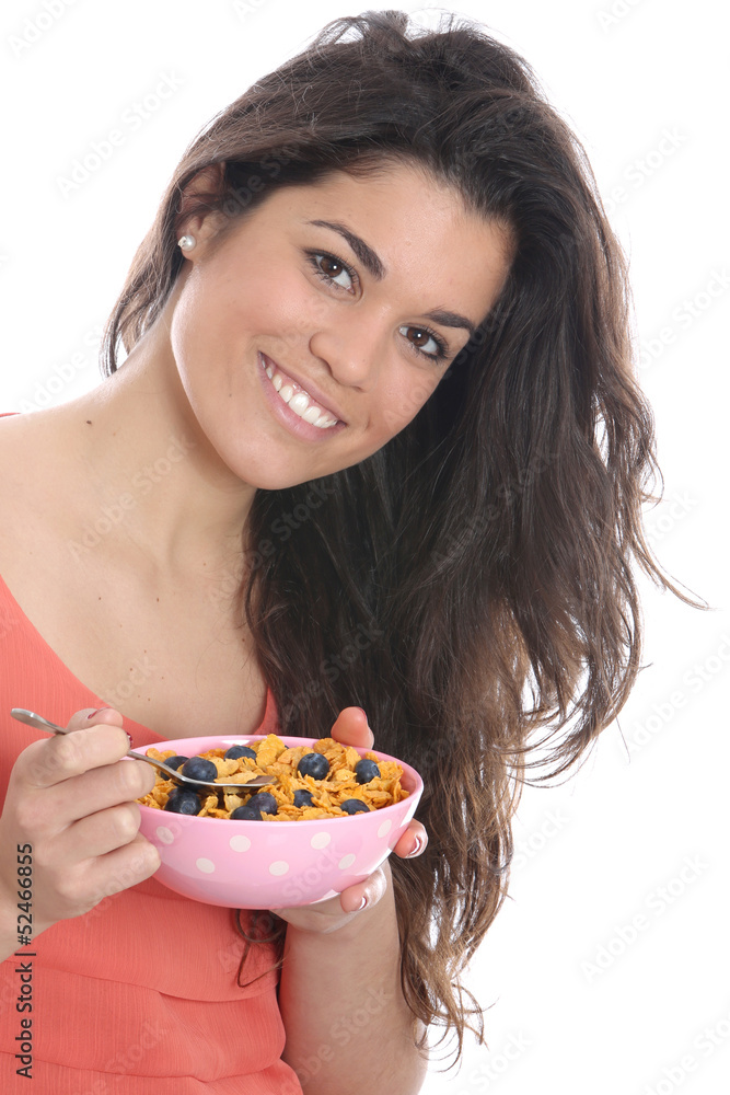Model Released. Young Woman Eating Breakfast Cereal Model Released. Young Woman Eating Breakfast Cereal