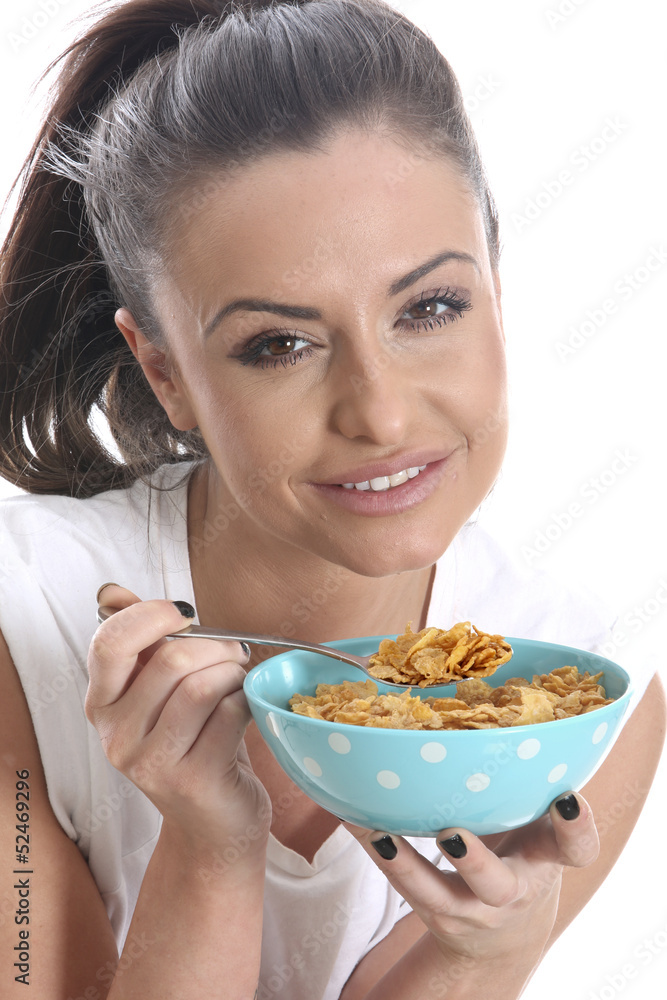 Model Released. Young Woman Eating a Bowl of Breakfast Cereal Model Released. Young Woman Eating a Bowl of Breakfast Cereal