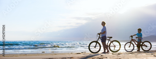 Mother and son biking at beach