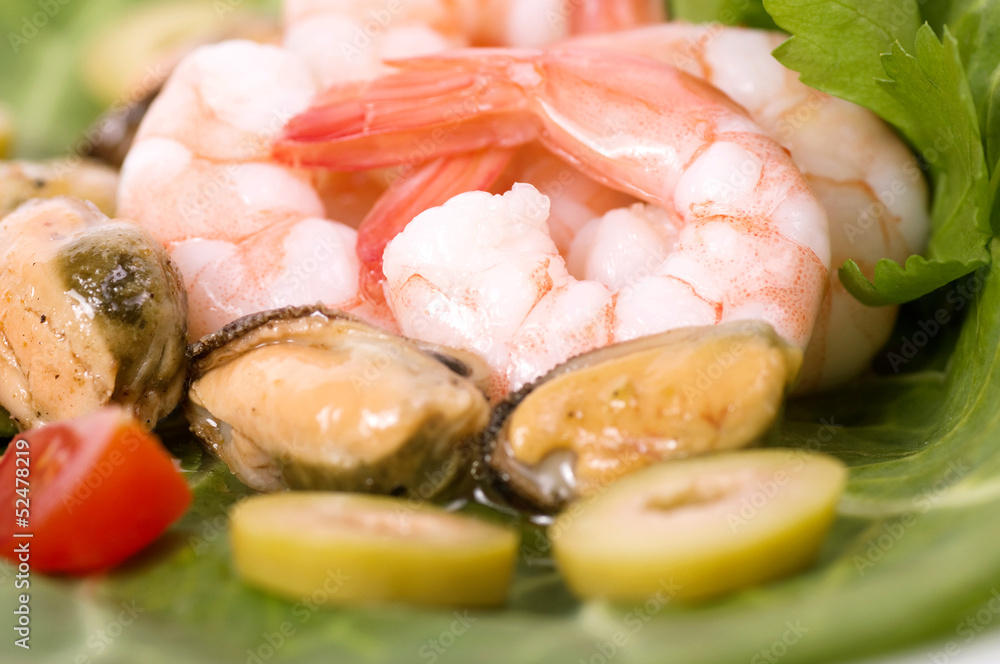 Tasty mussels and prawn food with salad and olives Tasty mussels and prawn food with salad and olives