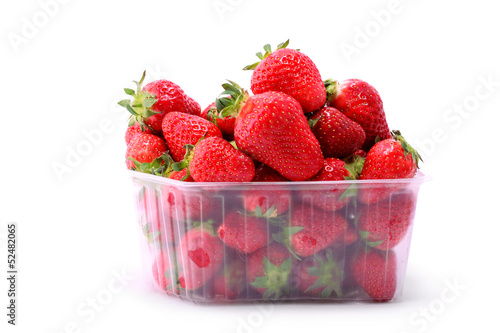 Fresh strawberries in plastic box on white background