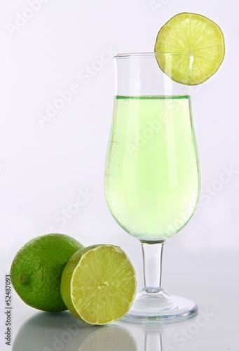 Green cocktail with lime isolated on white