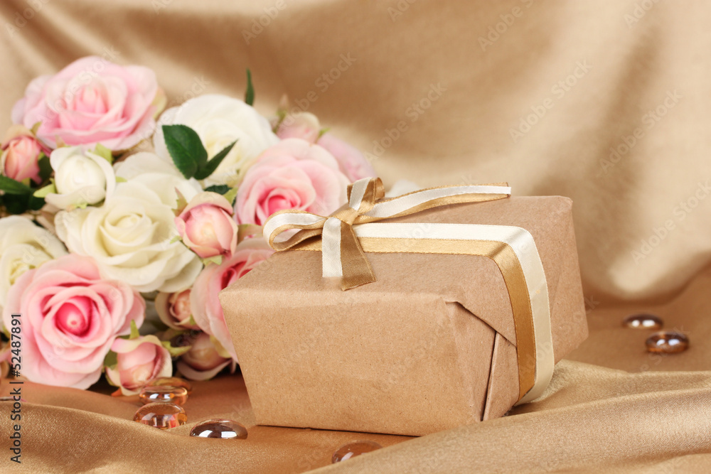 Beautiful gift on flowers background Beautiful gift on flowers background
