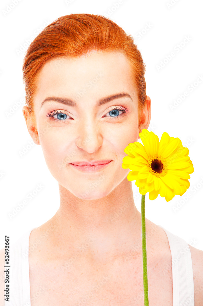 Woman with yellow flower near her face on white background