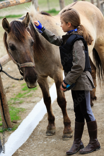 Horse and lovely equestrian girl, care for a horse
