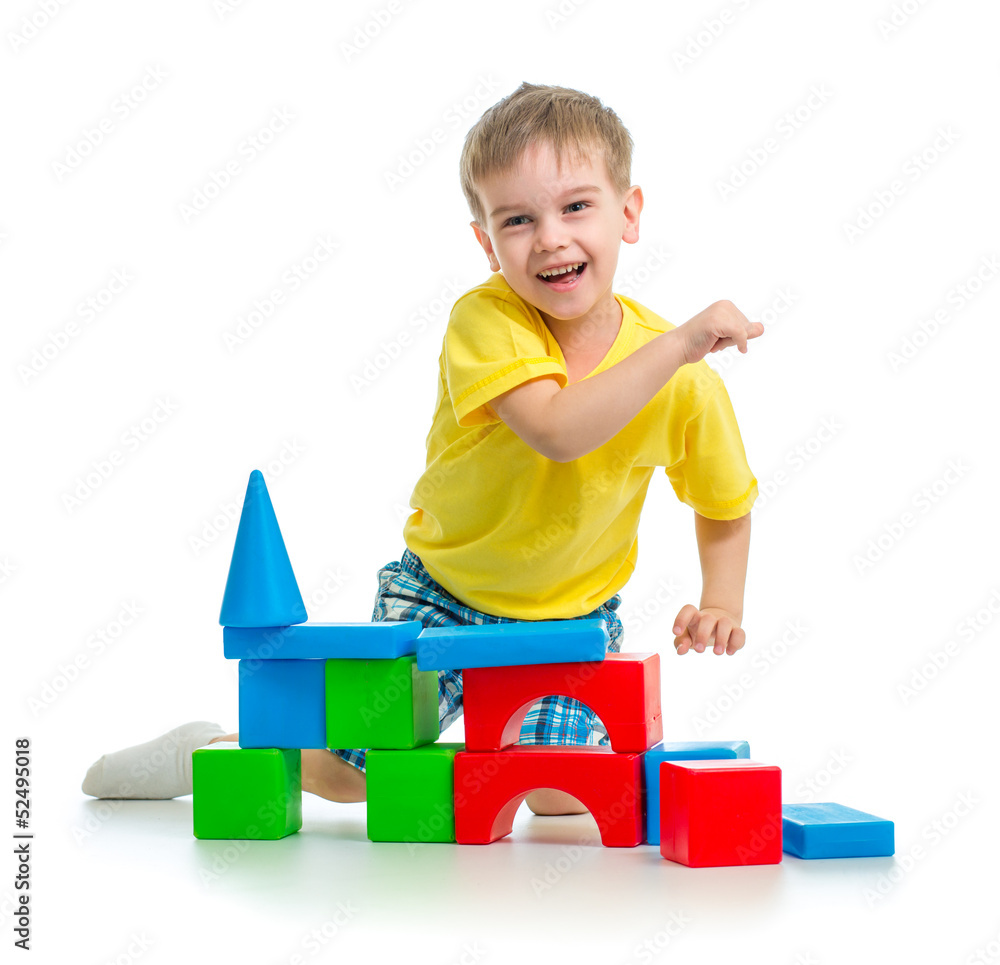 happy kid playing with colorful blocks isolated