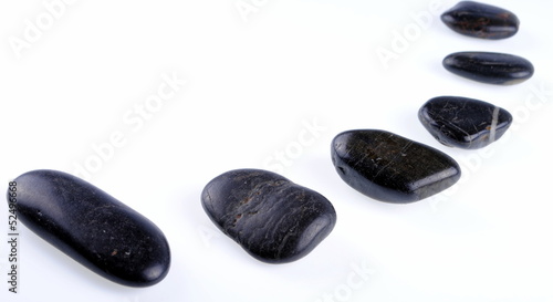 black zen stones on white background  soft shadows