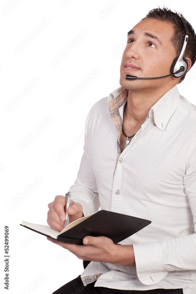 Man wearing a headset taking notes Man wearing a headset taking notes