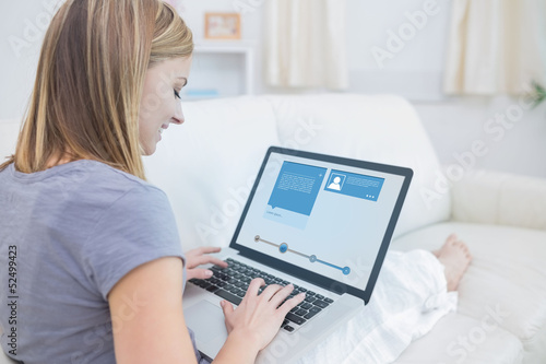 Woman sitting on sofa and checking her social media profile
