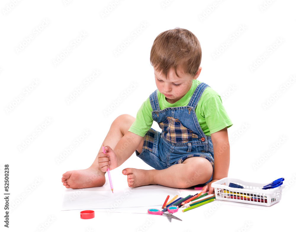 boy draws a pencil sitting on the floor boy draws a pencil sitting on the floor
