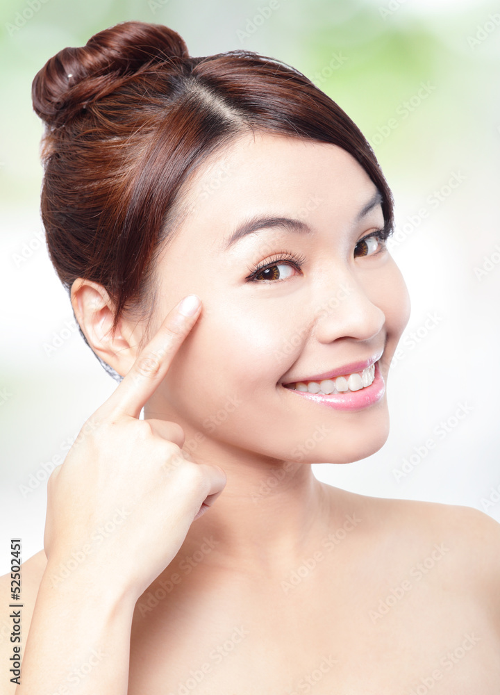 woman smile face and finger point to eyes