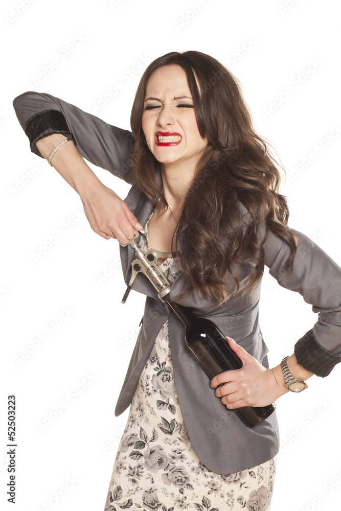 pretty girl has difficulties with opening a bottle of wine pretty girl has difficulties with opening a bottle of wine
